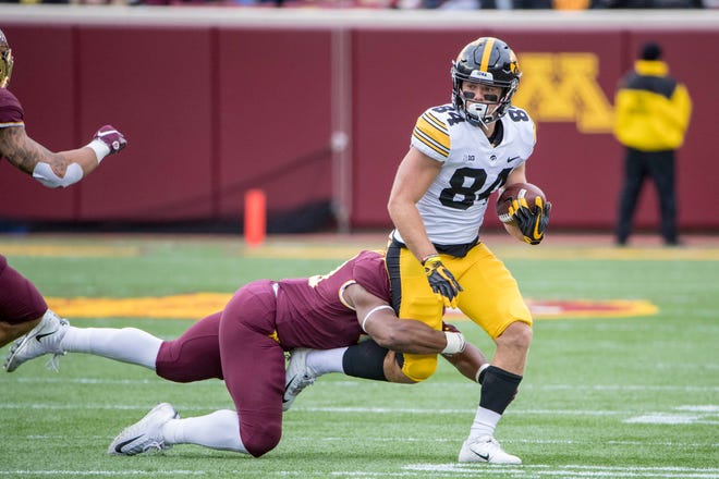 Oct 6, 2018; Minneapolis, MN, USA; Iowa Hawkeyes wide receiver Nick Easley (84) runs the ball after making a catch against Minnesota Golden Gophers linebacker Thomas Barber (41) in the first quarter at TCF Bank Stadium. Mandatory Credit: Jesse Johnson-USA TODAY Sports