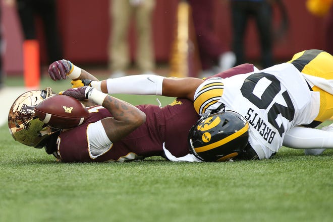 Minnesota wide receiver Rashod Bateman holds onto the ball in end zone after scoring a touchdown against Iowa's Julius Brents during an NCAA college football game Saturday, Oct. 6, 2018, in Minneapolis. Iowa won 48-31. (AP Photo/Stacy Bengs)
