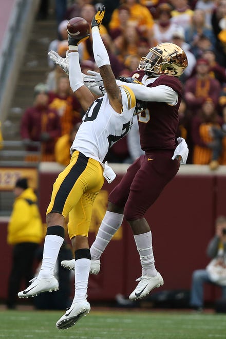 Iowa's Julius Brents intercepts the ball intended for Minnesota wide receiver Tyler Johnson during an NCAA college football game Saturday, Oct. 6, 2018, in Minneapolis. Iowa won 48-31. (AP Photo/Stacy Bengs)