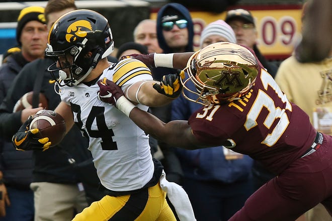 Iowa wide receiver Nick Easley holds off Minnesota's defensive back Kiondre Thomas during an NCAA college football game Saturday, Oct. 6, 2018, in Minneapolis. Iowa won 48-31. (AP Photo/Stacy Bengs)