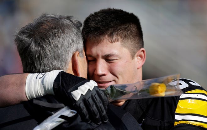 Iowa coach Kirk Ferentz, left, hugs his son, Iowa offensive linesman James Ferentz, during senior day ceremonies in 2012.