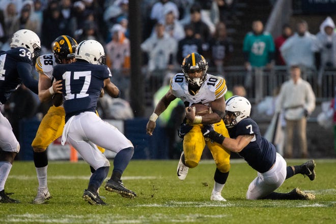 Mekhi Sargent #10 of the Iowa Hawkeyes is tackled by Koa Farmer #7 of the Penn State Nittany Lions during a game at Beaver Stadium on Saturday, October 27, 2018, in State College, Pennsylvania.