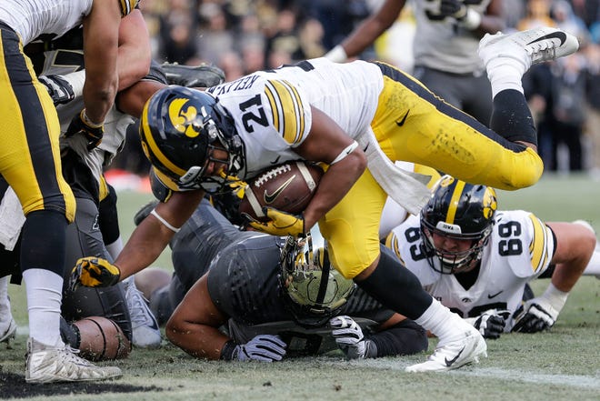 Iowa running back Ivory Kelly-Martin (21) scores a touchdown while playing against Purdue in the first half of an NCAA college football game in West Lafayette, Ind., Saturday, Nov. 3, 2018.