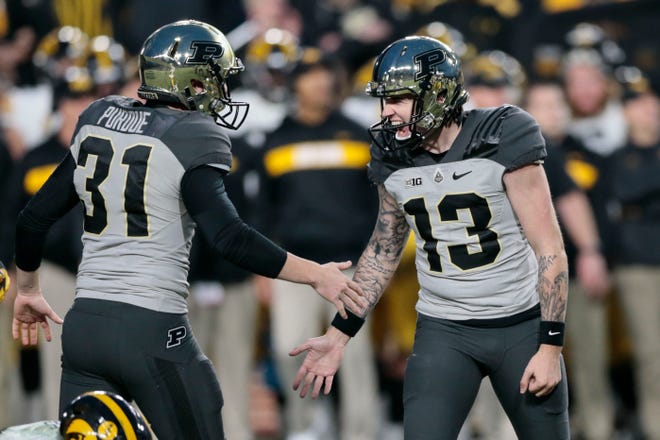 Purdue placekicker Spencer Evans (13) is congratulated by punter Joe Schopper (31) after booting the winning field goal in the fourth quarter of an NCAA college football game against Iowa in West Lafayette, Ind., Saturday, Nov. 3, 2018.