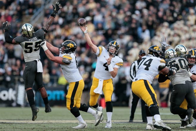 Iowa quarterback Nate Stanley (4) throws a pass as Purdue linebacker Derrick Barnes (55) leaps to defend against it in the first half of an NCAA college football game in West Lafayette, Ind., Saturday, Nov. 3, 2018.