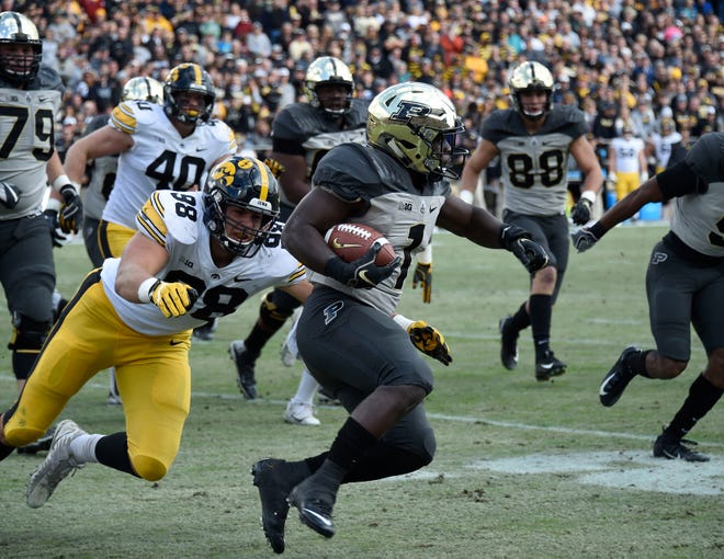 Nov 3, 2018; West Lafayette, IN, USA;  Iowa Hawkeyes defensive end Anthony Nelson (98) attempts a tackle on Purdue Boilermakers running back D.J. Knox (1) at Ross-Ade Stadium.