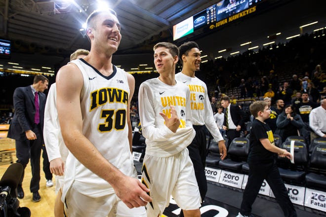 Iowa guard Connor McCaffery (30) talks with teammates Austin Ash (center) and Cordell Pemsl (right) after an NCAA men's basketball game in the 2K Empire Classic on Sunday, Nov. 11, 2018, at Carver-Hawkeye Arena in Iowa City.
