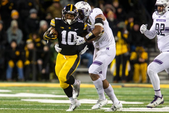 Iowa running back Mekhi Sargent (10) gets tackled by Northwestern's Nate Hall (32) during a Big Ten Conference football game on Saturday, Nov. 10, 2018, at Kinnick Stadium in Iowa City.