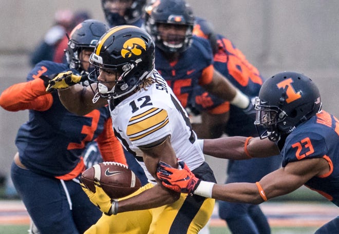 Iowa's Brandon Smith runs with the ball in the first half of a NCAA college football game against Illinois, Saturday, Nov. 17, 2018, in Champaign, Ill.