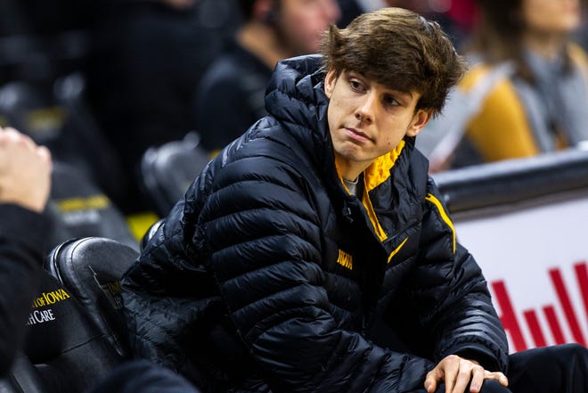 Iowa City West senior Patrick McCaffery sits on the bench during warmups before an NCAA men's basketball game on Wednesday, Nov. 21, 2018, at Carver-Hawkeye Arena in Iowa City.