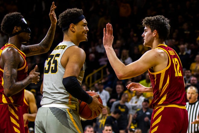 Iowa forward Cordell Pemsl (35) reacts after getting called for a foul while Iowa State forward Zoran Talley Jr. (left) high-fives Iowa State forward Michael Jacobson (12) during a NCAA Cy-Hawk series men's basketball game on Thursday, Dec. 6, 2018, at Carver-Hawkeye Arena in Iowa City.