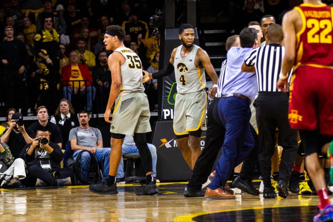 Iowa forward Cordell Pemsl (35) reacts while players get separated back to their benches while Iowa guard Isaiah Moss (4) looks on during a NCAA Cy-Hawk series men's basketball game on Thursday, Dec. 6, 2018, at Carver-Hawkeye Arena in Iowa City.