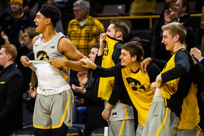 Iowa forward Cordell Pemsl (left) celebrates with Riley Till, Austin Ash and Michael Baer during a NCAA Cy-Hawk series men's basketball game on Thursday, Dec. 6, 2018, at Carver-Hawkeye Arena in Iowa City.