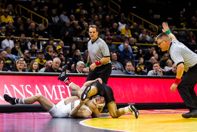 Iowa's Pat Lugo, top, scores a near fall Lehigh's Jimmy Hoffman at 149 during a NCAA wrestling dual on Saturday, Dec. 8, 2018, at Carver-Hawkeye Arena in Iowa City.