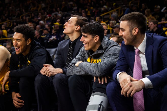 Iowa's Cordell Pemsl, Jack Nunge, Luka Garza and Connor McCaffery laugh on the bench during a NCAA men's basketball game on Saturday, Dec. 22, 2018, at Carver-Hawkeye Arena in Iowa City.