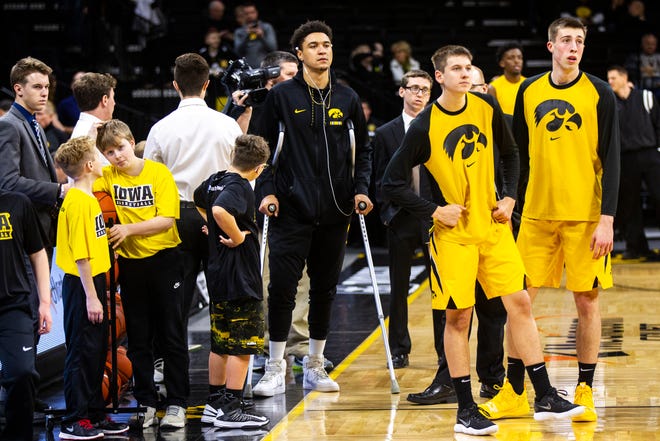 Iowa forward Cordell Pemsl watches while teammates warm up before a NCAA men's basketball game against Savannah State on Saturday, Dec. 22, 2018, at Carver-Hawkeye Arena in Iowa City. Pemsl had a procedure to remove hardware near his knee on Dec. 18.