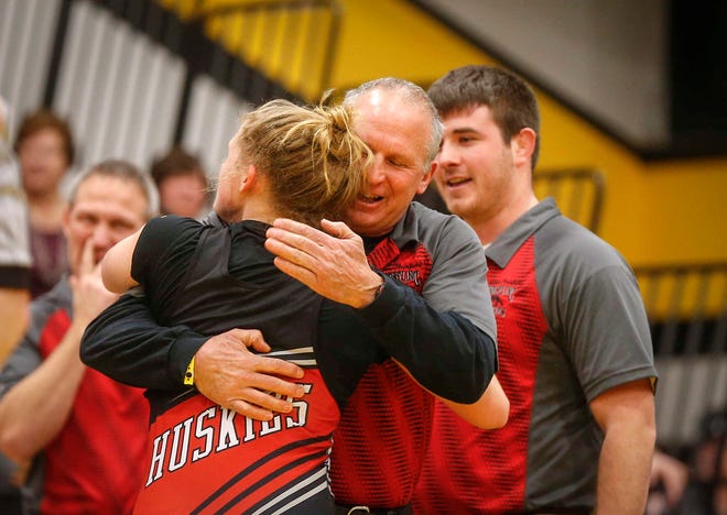 Nashua-Plainfield wrestling coach Al Frost hugs sophomore Toyia Griffin pinned Waverly-Shell Rock's Hedda Kveum in 16 seconds of the first period to win a state title at 152 pounds on Saturday, Jan. 19, 2019, during the first Iowa girls state wrestling tournament at Waverly-Shell Rock High School in Waverly.