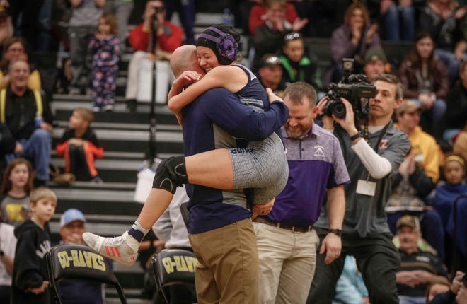 AGWSR junior Ali Gerbracht hugs her coach after making state history on Saturday, Jan. 19, 2019, during the first Iowa girls state wrestling tournament at Waverly-Shell Rock High School in Waverly. After a win at 106-pounds, Gerbracht was the first Iowa high school girl to win on state title on Saturday.