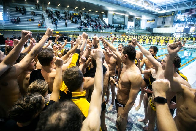 Iowa Hawkeyes huddle up after a NCAA Big Ten Conference swimming meet on Saturday, Jan. 19, 2019, at the Campus Recreation and Wellness Center in Iowa City, Iowa.