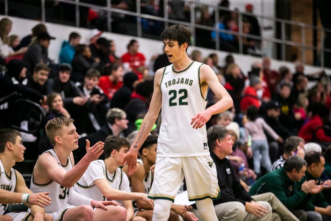 Iowa City West's Patrick McCaffery (22) high-fives teammate Even Brauns (34) while heading to the bench during a Class 4A boys' basketball game on Thursday, Jan. 31, 2019, at West High School in Iowa City, Iowa.