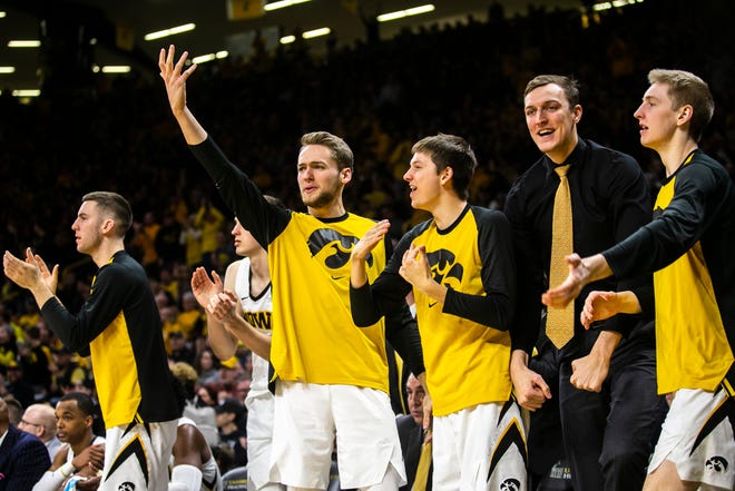 Iowa forward Riley Till (raising hand) celebrates with teammates (from left) Connor McCaffery, Austin Ash, Jack Nunge and Michael Baer during a NCAA Big Ten Conference men's basketball game on Friday, Feb. 1, 2019, at Carver-Hawkeye Arena in Iowa City, Iowa.
