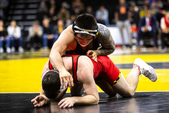 Iowa's Pat Lugo, top, wrestles Maryland's Pete Tedesco at 149 during a NCAA Big Ten Conference wrestling dual on Friday, Feb. 8, 2019 at Carver-Hawkeye Arena in Iowa City, Iowa.