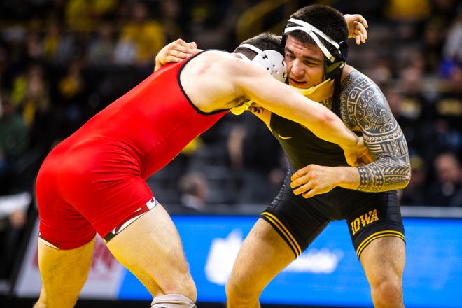 Iowa's Pat Lugo, right, wrestles Maryland's Pete Tedesco at 149 during a NCAA Big Ten Conference wrestling dual on Friday, Feb. 8, 2019 at Carver-Hawkeye Arena in Iowa City, Iowa.