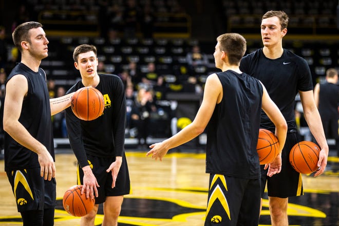 Iowa's Connor McCaffery (from left) C.J. Fredrick, Austin Ash and Jack Nunge go through warmups before a NCAA Big Ten Conference men's basketball game against Indiana on Friday, Feb. 22, 2019 at Carver-Hawkeye Arena in Iowa City, Iowa.