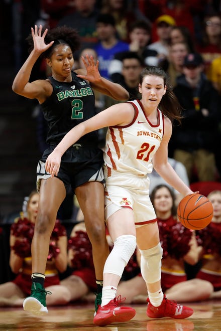 Iowa State guard Bridget Carleton (21) drives around Baylor guard DiDi Richards, left, during the first half of an NCAA college basketball game, Saturday, Feb. 23, 2019, in Ames, Iowa.
