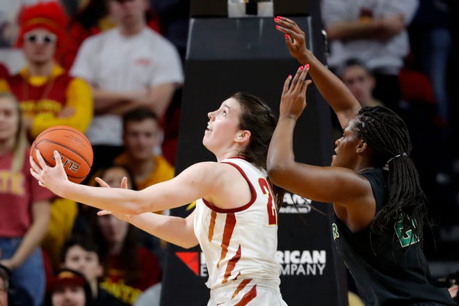 Iowa State guard Bridget Carleton, left, drives to the basket past Baylor center Kalani Brown, right, during the first half of an NCAA college basketball game, Saturday, Feb. 23, 2019, in Ames, Iowa.