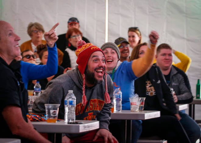 Adam Szymczuk of Urbandale reacts favorably as Auburn takes the lead over New Mexico State as fans gathered inside the beer tent at Cowles Commons to watch the games on the four large television units on Thursday, March 21, 2019, in Des Moines.
