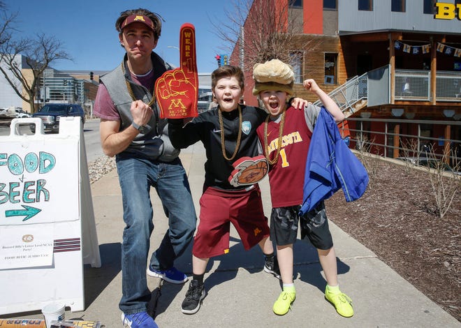 Minnesota Gopher basketball fans Ethan Bischoff and his sons Will, 11, and Henry, 9, of St. Paul, celebrate after Minnesota beat Louisville on Thursday, March 21, 2019, in Des Moines.