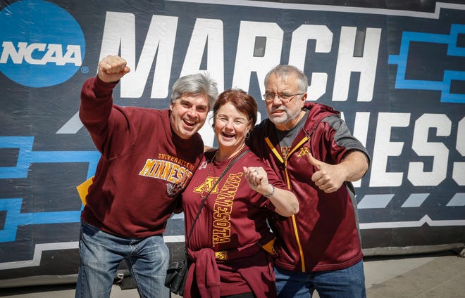 Minnesota Gopher basketball fans Warren and Linda Wessel of Maple Grove, Minn., and Tim Dickinson of Cottage Grove, Minn., (right) celebrate after Minnesota beat Louisville on Thursday, March 21, 2019, in Des Moines.