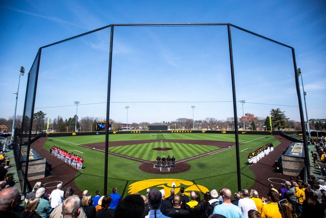 Rutgers and Iowa players stand for the national anthem during a NCAA Big Ten Conference baseball game on Saturday, April 6, 2019, at Duane Banks Field in Iowa City, Iowa.