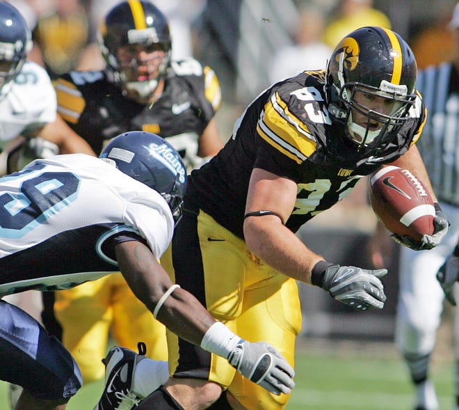Iowa's Brandon Myers tries to avoid Maine's Trevor Coston in first quarter of a game on Aug. 30, 2008 in Iowa City, Iowa.