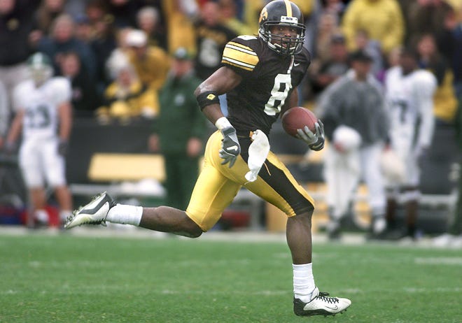 C.J. Jones (2001-2002) looks over his shoulder after making a reception in the second quarter and taking it in for a touchdown during Iowa's 44-16 win over Michigan State on Oct. 12, 2002. Jones finished his career with 12 touchdowns, including a score on the opening kickoff of the 2003 Orange Bowl against USC.