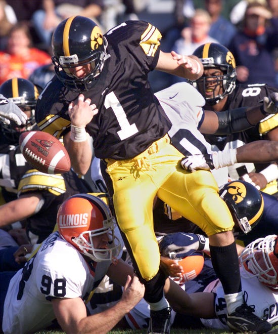Tim Dodge (1998-2001) tries to corral a loose ball during a first-half kickoff return against Illinois on Nov. 6, 1999 at Kinnick Stadium.