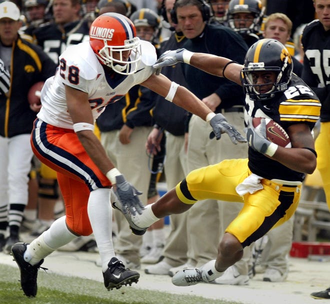 Iowa City native Calvin Davis (2003-2006) is pushed out of bounds by an Illinois defender after a 26-yard gain during a Nov. 1, 2003 contest at Kinnick Stadium.