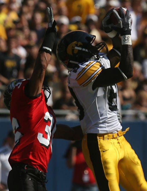 James Cleveland (2007-2010) catches a pass in front of Northern Illinois' Chase Carter on Sept. 1, 2007 at Soldier Field, in Chicago, Ill.