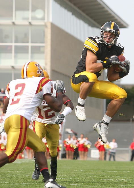 Colin Sandeman (2007-2010) makes a leaping catch in front of Iowa State's James Smith (2) and Allen Bell (12) in a  Sept. 15, 2007 contest in Ames.