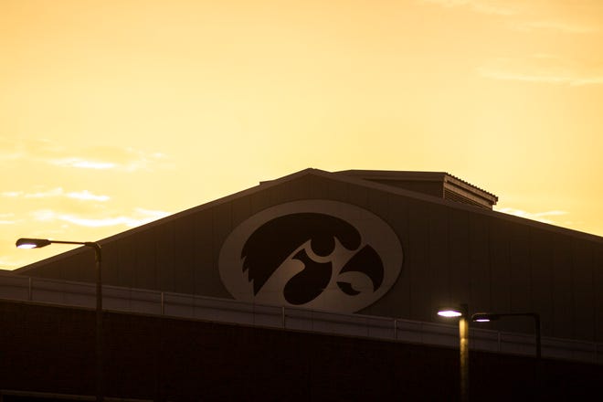 A Tigerhawk logo is illuminated as the sun sets, Sunday, June 30, 2019, at the Hansen Football Performance Center in Iowa City, Iowa.
