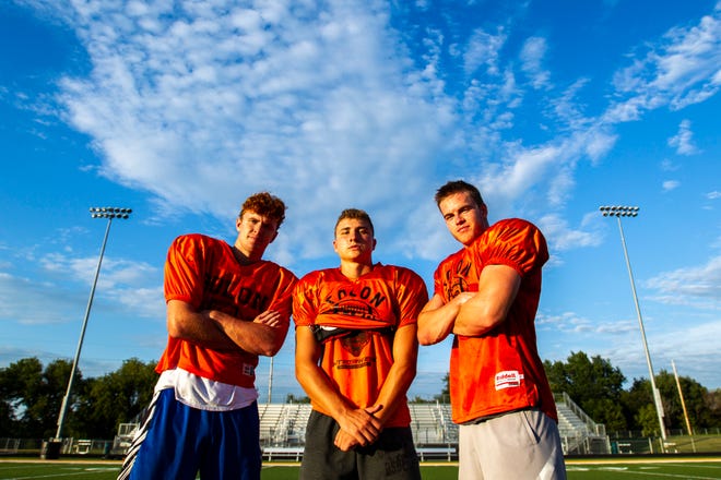 Solon wide receiver A.J. Coons, from left, quarterback Cam Miller, and wide receiver Jace Andregg pose for a photo after a varsity football practice, Thursday, Aug. 15, 2019, at Spartan Stadium in Solon, Iowa.
