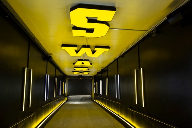 Yellow letters that spell out "Swarm" on the ceiling in the tunnel that leads towards the field is pictured during a behind the scenes tour, Friday, Aug. 23, 2019, at Kinnick Stadium in Iowa City, Iowa.