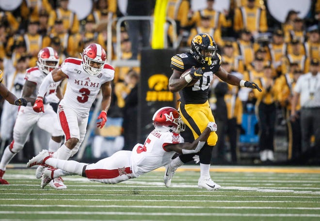 Iowa junior running back Mekhi Sargent is caught by Miami of Ohio (and former Hawkeye) cornerback Manny Rugamba in the first quarter at Kinnick Stadium in Iowa City on Saturday, Aug. 31, 2019.