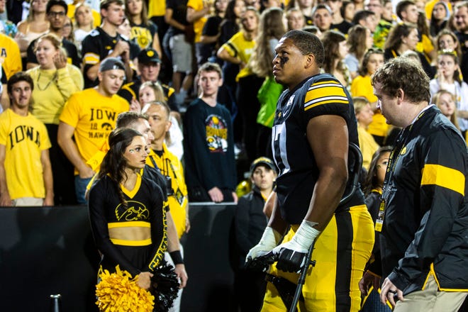 Iowa offensive lineman Alaric Jackson (77) walks off the field on crutches during a NCAA non conference football game, Saturday, Aug. 31, 2019, at Kinnick Stadium in Iowa City, Iowa.