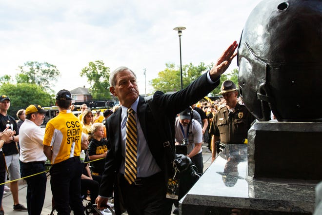 Iowa head coach Kirk Ferentz reaches out to touch the helmet of the Nile Kinnick statue before a NCAA Big Ten Conference football game against Rutgers, Saturday, Sept. 7, 2019, at Kinnick Stadium in Iowa City, Iowa.