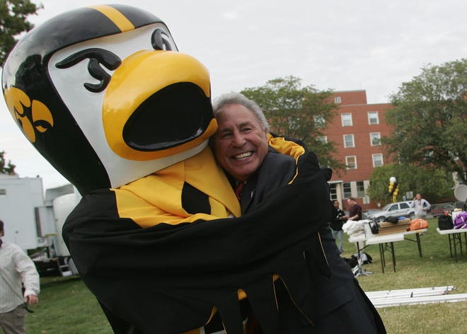 Lee Corso hugs Iowa masscot Herky after broadcasting aa live show of ESPN ' s College Gameday from Hubbard Park, on the University of Iowa Campus, in Iowa City, Iowa Friday September 29,2006 in preparation for Saturday ' s matchup of Iowa and Ohio State.