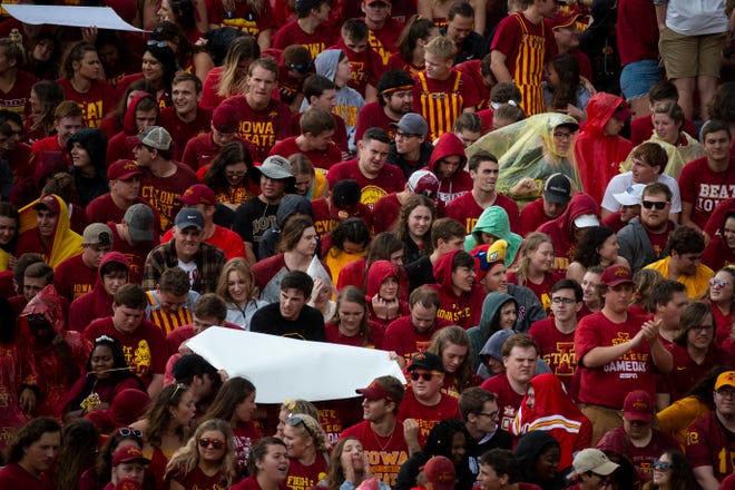 Iowa State fans take cover during a lightning delay during the Cy-Hawk football game at Jack Trice Stadium on Saturday, Sept. 14, 2019 in Ames. A lightning strike forced a delay in the first quarter.