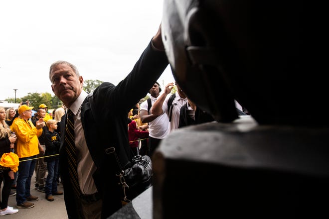 Iowa head coach Kirk Ferentz reaches out to touch the helmet of the Nile Kinnick statue before a NCAA non conference football game against Middle Tennessee State, Saturday, Sept., 28, 2019, at Kinnick Stadium in Iowa City, Iowa.