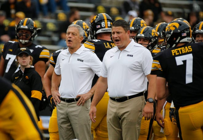 Iowa head football coach Kirk Ferentz, left, and assistant coach Brian Ferentz, right, watch the Hawkeyes warm up prior to kickoff against Middle Tennessee at Kinnick Stadium on Saturday, Sept. 28, 2019, in Iowa City.